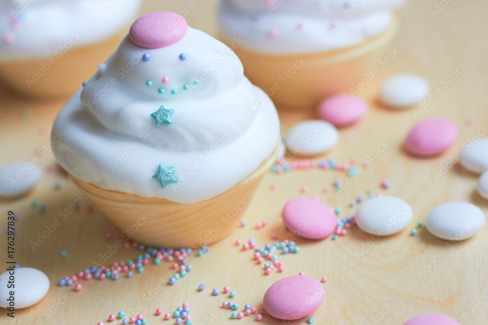 Christmas cupcakes with whipped cream in the form of a snowman. Sweets for children's holiday Christmas cupcakes with whipped cream in the form of a snowman. Sweets for children's holiday