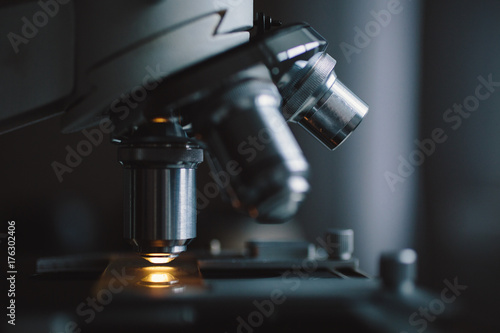 Close-up shot of microscope with metal lens at laboratory.