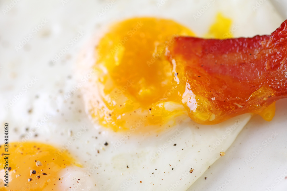Bacon dipped in egg yolk macro Bacon dipped in egg yolk macro