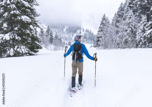 Man Snowshoeing Through a Winter Scene