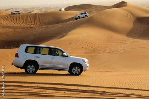 Photography White cars in desert next to Dubai