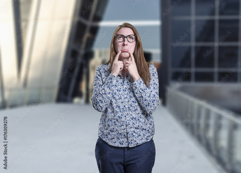 Pretty business woman making a sad gesture with glasses