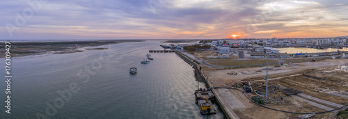 Sunset aerial panoramic seascape view of Olhao dockyard, waterfront to Ria Formosa natural park and Armona island. Algarve.