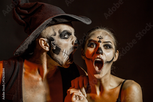 Halloween. Passionate couple kissing, boy and girl. Having sex. Young lovers. People in love. Positions kamasutra. Erotic moments. Concept photo. Secret. Fashion. Hot babe. Party. Night background. 