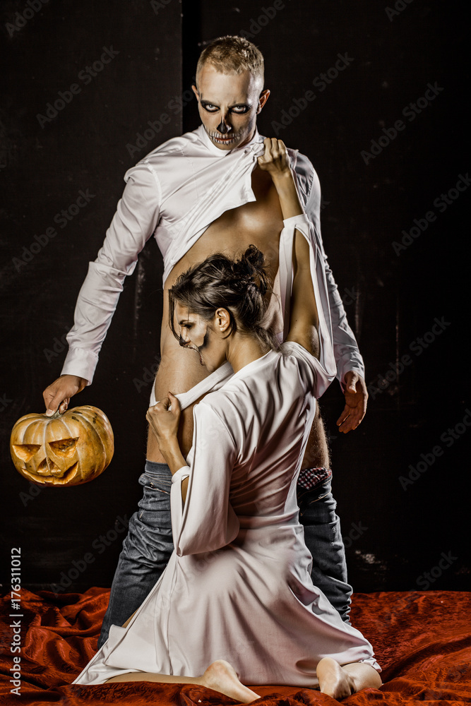 Halloween couple. Halloween photo. Sexy woman and angry man. Erotic photo.  Sexy couple. Sensual. Photos | Adobe Stock