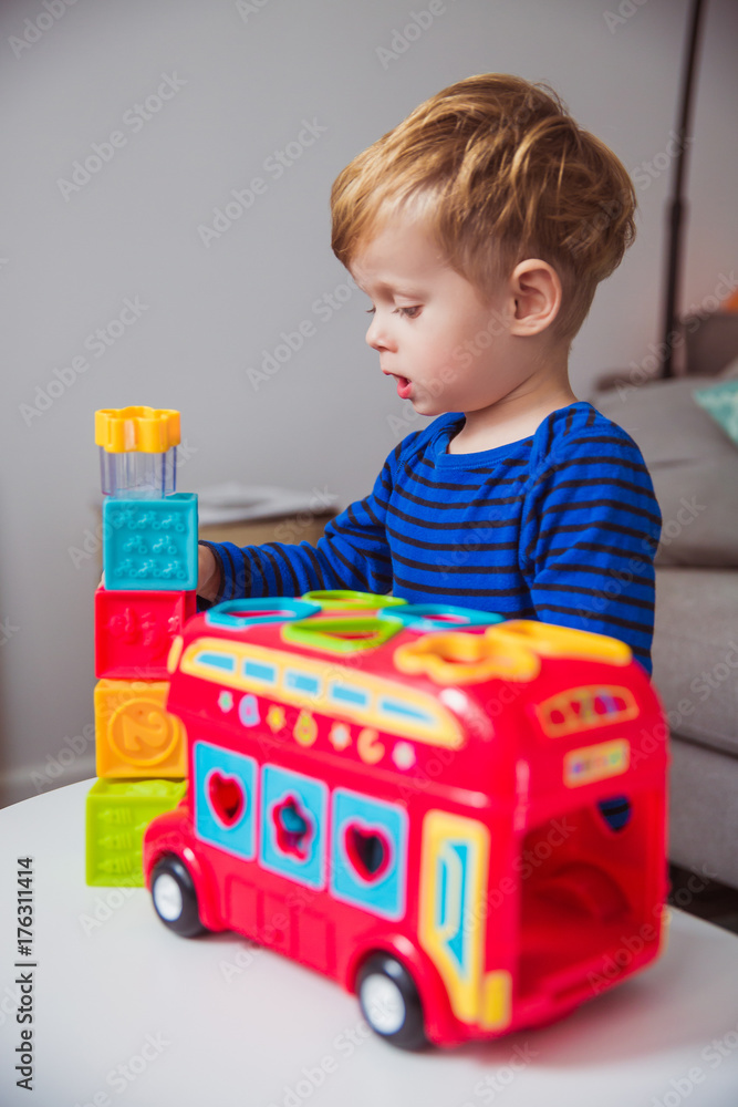 Portrait of little cute boy who playing with color toys at home Portrait of little cute boy who playing with color toys at home