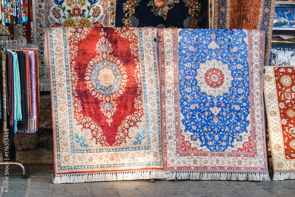 Two colorful silk carpets and rugs at the store in Istanbul Bazar, Turkey