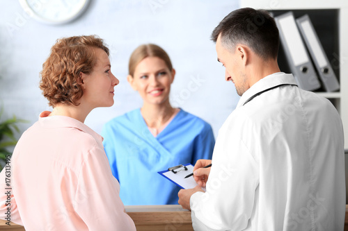 Receptionist and doctor wit...