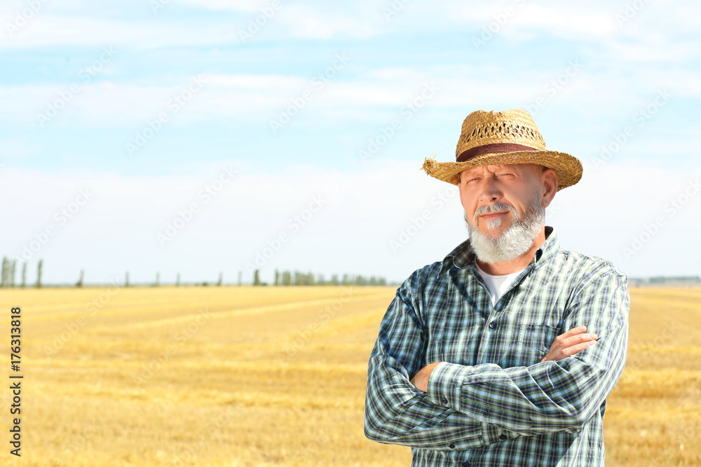 Mature farmer standing in field