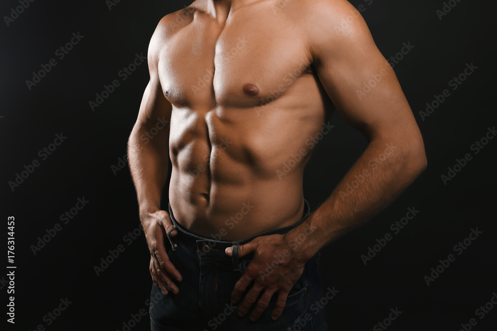 Muscular man on dark background Muscular man on dark background