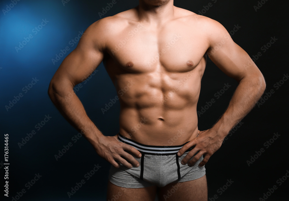 Fototapeta premium Muscular man in underwear on dark background