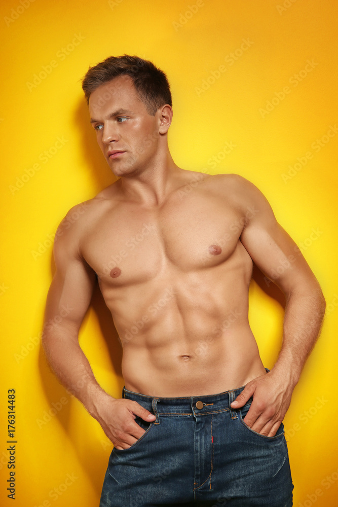 Muscular man on color background