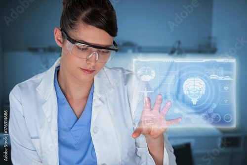 Composite image of beautiful female scientist using digital