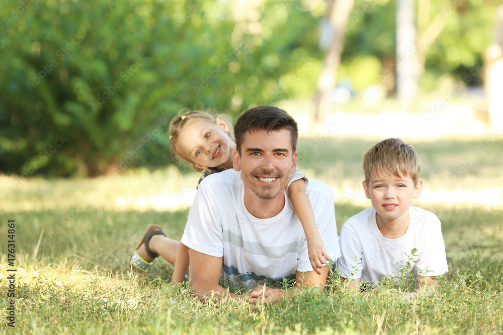 Fototapeta premium Father with children in park on sunny day