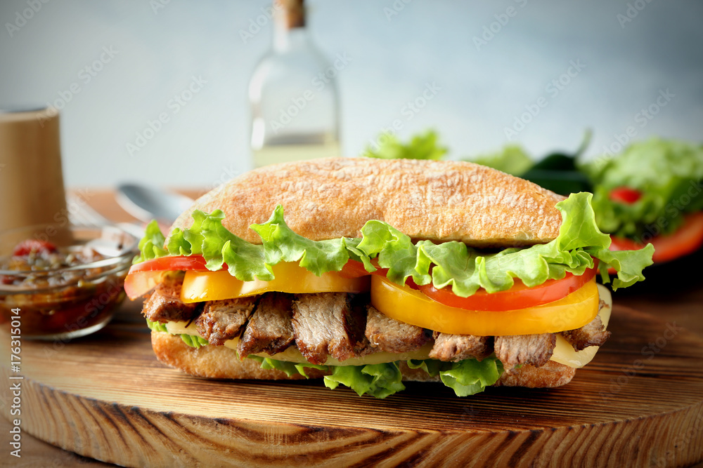 Tasty steak sandwich on wooden board Tasty steak sandwich on wooden board