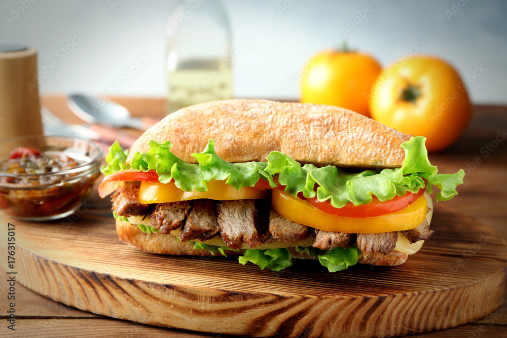 Tasty steak sandwich on wooden board Tasty steak sandwich on wooden board