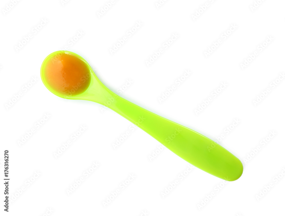 Plastic spoon with baby food on white background Plastic spoon with baby food on white background