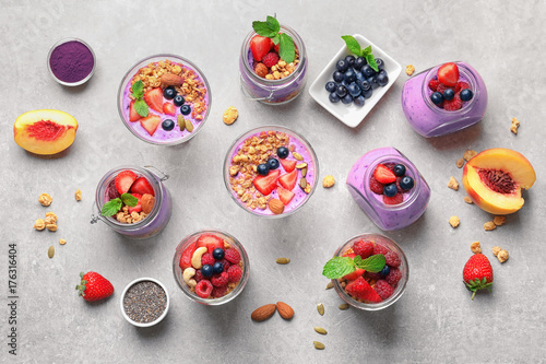 Composition of healthy breakfast with delicious acai smoothie on light background