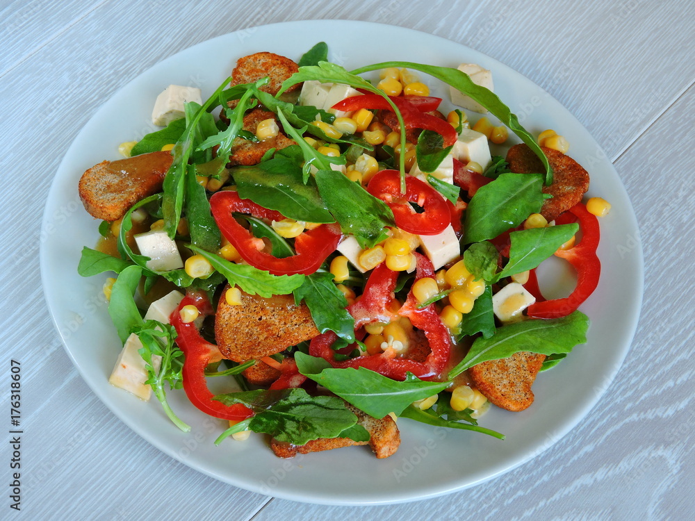 Salad on a plate. Fitness salad with corn. Nutritious fitness salad.Arugula corn pepper cheese. Top view. Salad on a plate. Fitness salad with corn. Nutritious fitness salad.Arugula corn pepper cheese. Top view.