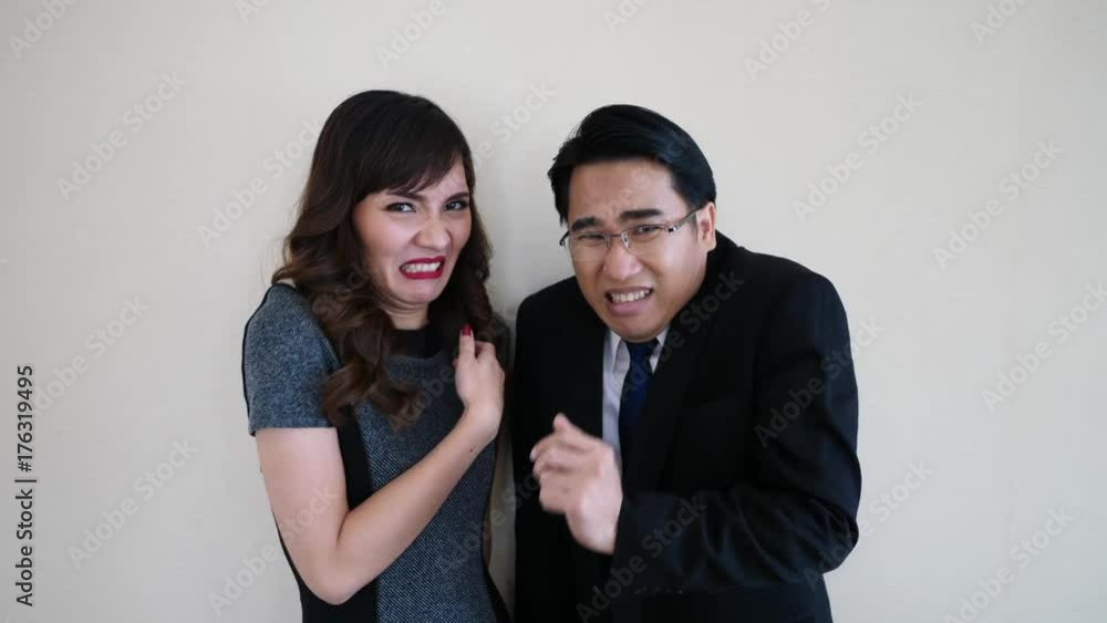 Young male and female looking at each other, colleagues expressing instant dislike, hate or envy, coworkers showing jealousy. Young male and female looking at each other, colleagues expressing instant dislike, hate or envy, coworkers showing jealousy.