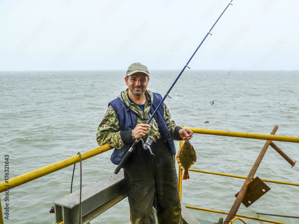 Fototapeta premium Flounder on the deck. Fishing on the boat. Bottom fish