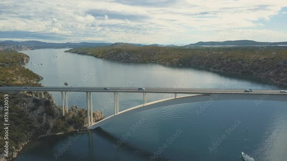 Aerial panorama view with bridge and sea around islands. Beautiful landscape surrounded with blue sea with bridge between. Autostrada bridge with traffic over Krka river at sunny day in Croatia. Aerial panorama view with bridge and sea around islands. Beautiful landscape surrounded with blue sea with bridge between. Autostrada bridge with traffic over Krka river at sunny day in Croatia.