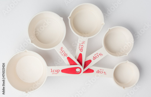Set of Fanned Measuring Cups on White Background Top View
