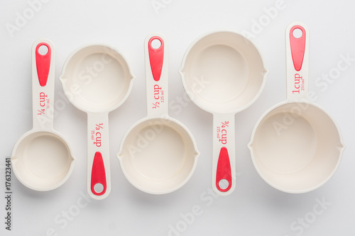 Set of Measuring Cups Staggered on White Background Top View photo