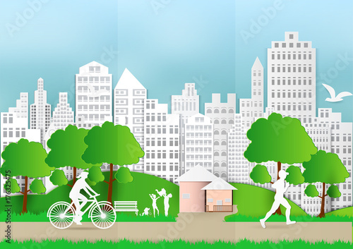 Paper art of people and pets with city and bicycle on green background, ecology idea