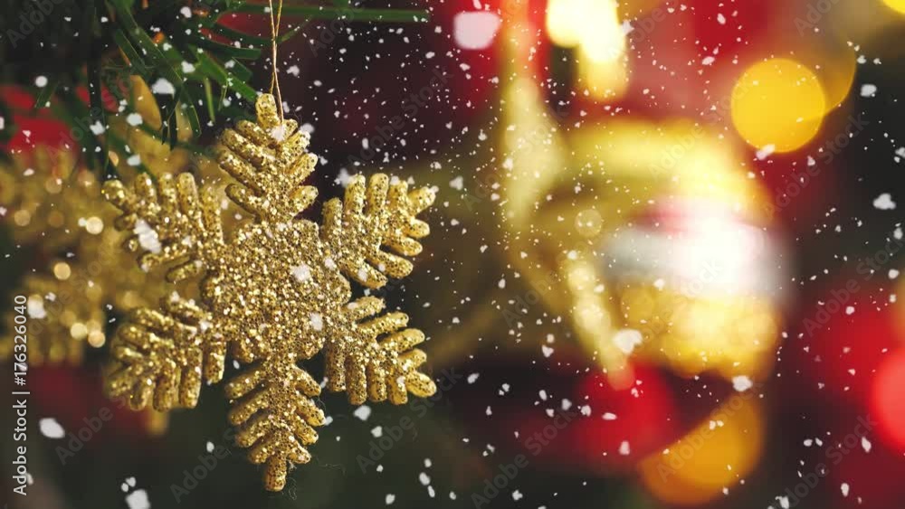 Greeting Season concept.Macro with Dolly of ornaments on a Christmas tree with decorative light and falling snow in 4k (UHD)