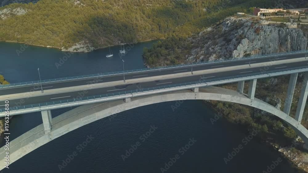 Aerial panorama view with bridge and sea around islands. Beautiful landscape surrounded with blue sea with bridge between. Autostrada bridge with traffic over Krka river at sunny day in Croatia. Aerial panorama view with bridge and sea around islands. Beautiful landscape surrounded with blue sea with bridge between. Autostrada bridge with traffic over Krka river at sunny day in Croatia.
