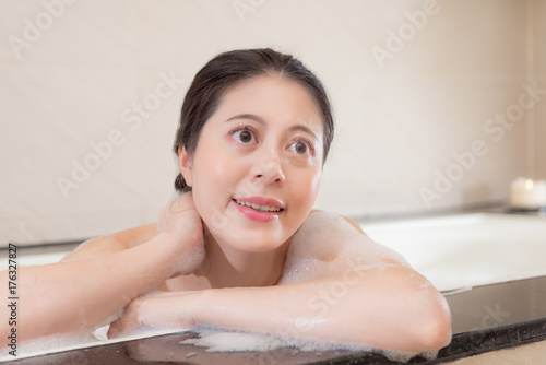 happy female student relaxing in bathroom bathtub