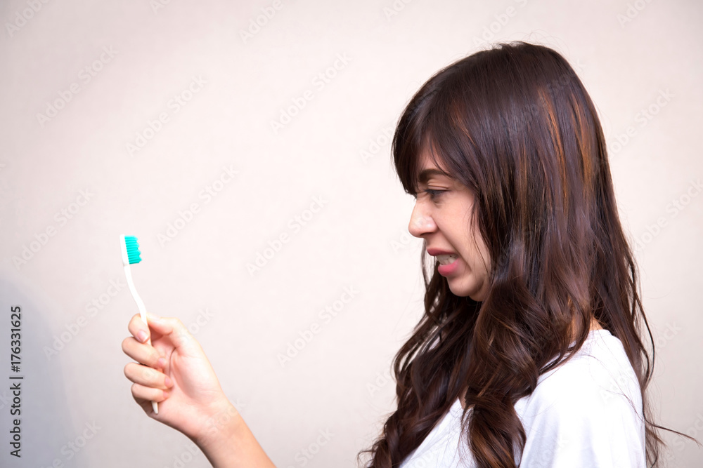 young woman refuse to brush her teeth. concept for healty care