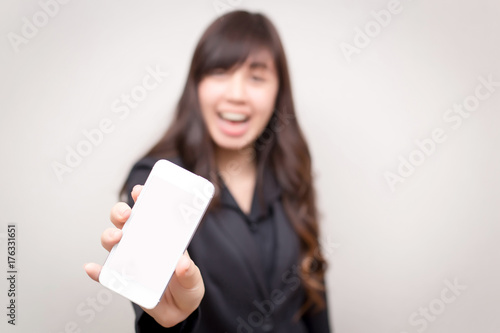 Happy confident businesswoman show her smartphone. concept for business and communication.