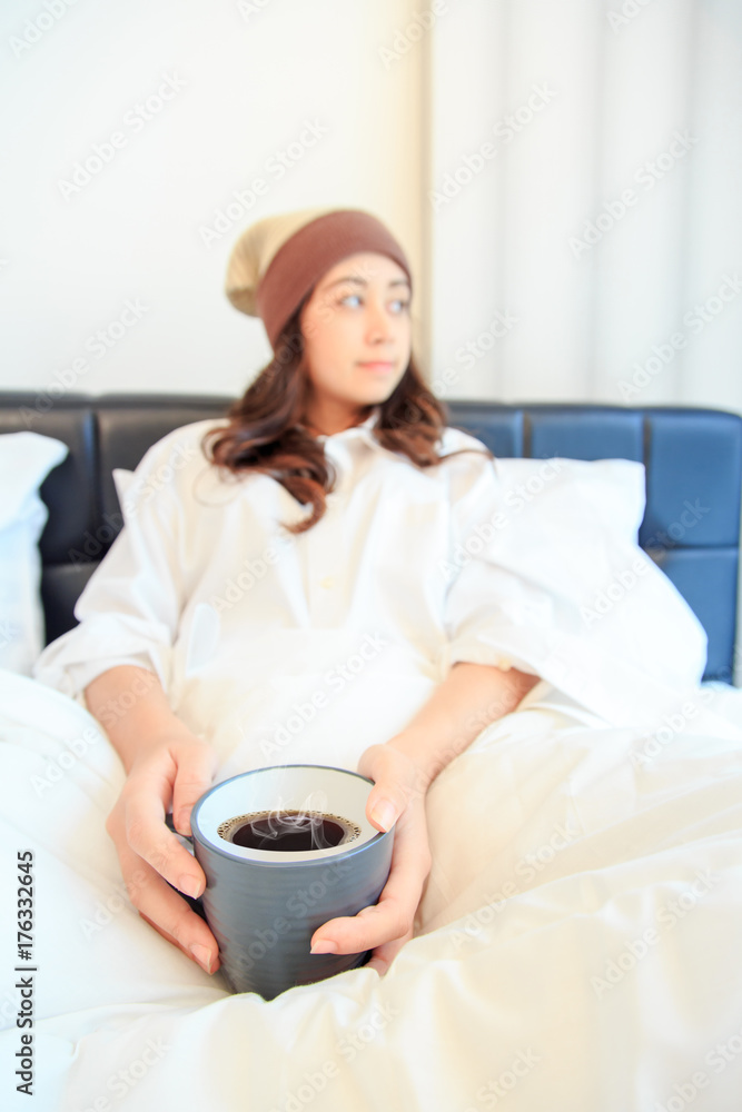 Portrait of a beautiful young lady drinking her morning coffee in her bedroom Portrait of a beautiful young lady drinking her morning coffee in her bedroom