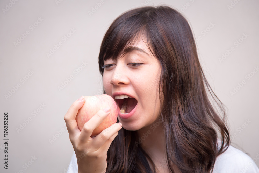 portrait of pretty woman eating an apple close up. concept for healthy care portrait of pretty woman eating an apple close up. concept for healthy care
