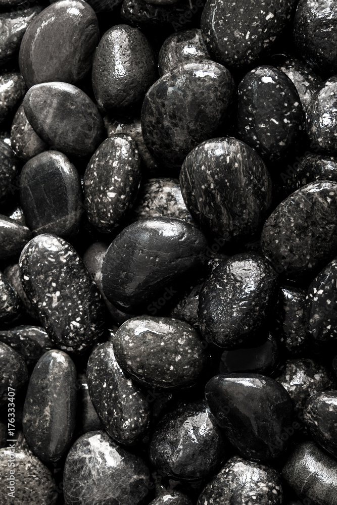 Round black stone on ground beside the waterfall Round black stone on ground beside the waterfall