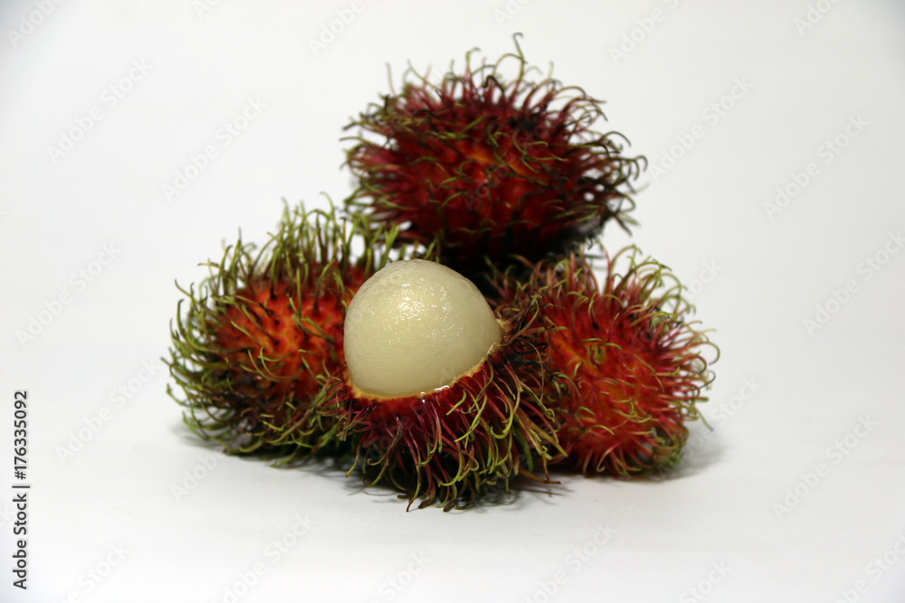 Five rambutan on the White background. it is a red, plum-sized tropical fruit with soft sweet. Five rambutan on the White background. it is a red, plum-sized tropical fruit with soft sweet.