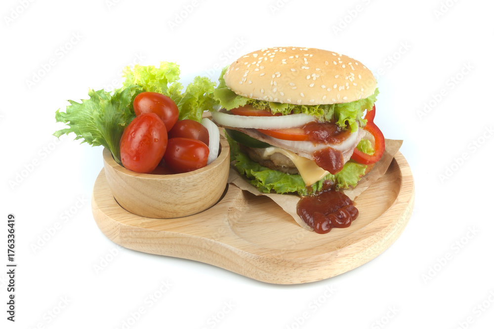 Pork hamburger Homemade with grilled bacon contains vegetables, cheese, lettuce, onion, chilli, spices in a wooden dish isolated on white backgroud Pork hamburger Homemade with grilled bacon contains vegetables, cheese, lettuce, onion, chilli, spices in a wooden dish isolated on white backgroud