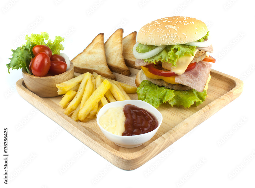 Pork hamburger Homemade with grilled bacon contains vegetables, cheese, lettuce, onion, chilli, spices in a wooden dish isolated on white backgroud