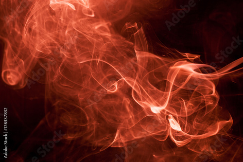 Red smoke on a black background.