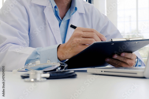 close up of patient and doctor taking notes or Professional medical doctor in white uniform gown coat interview   