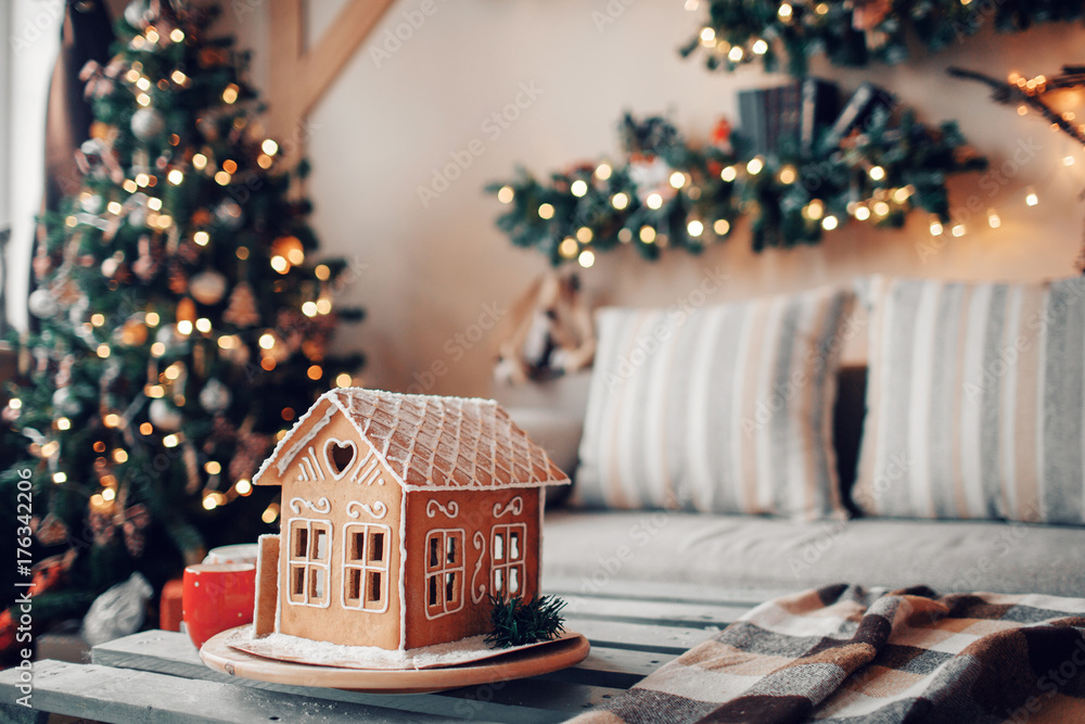 Homemade gingerbread house on light room background Homemade gingerbread house on light room background