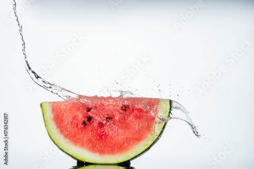 watermelon and water splash on white
