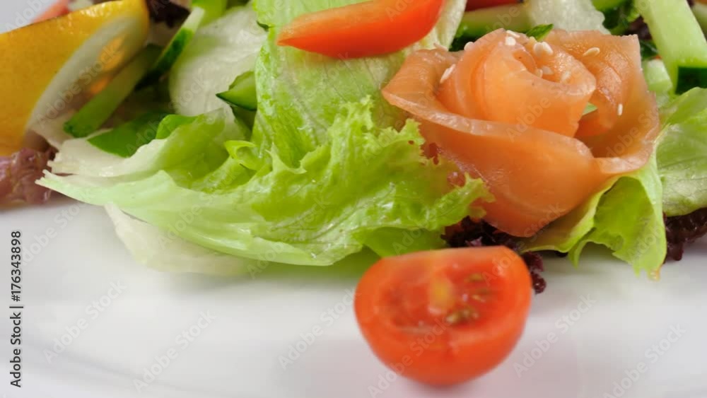 Fish salad, close-up view, Salmon with vegetables, served with cherry tomatoes, sesame seed, cucumber and bell pepper, loop, 4K, ProRes codec, 422 HQ Fish salad, close-up view, Salmon with vegetables, served with cherry tomatoes, sesame seed, cucumber and bell pepper, loop, 4K, ProRes codec, 422 HQ