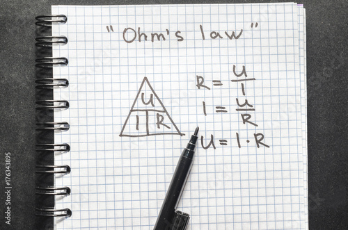 Page with formulas and Ohm's law with pen