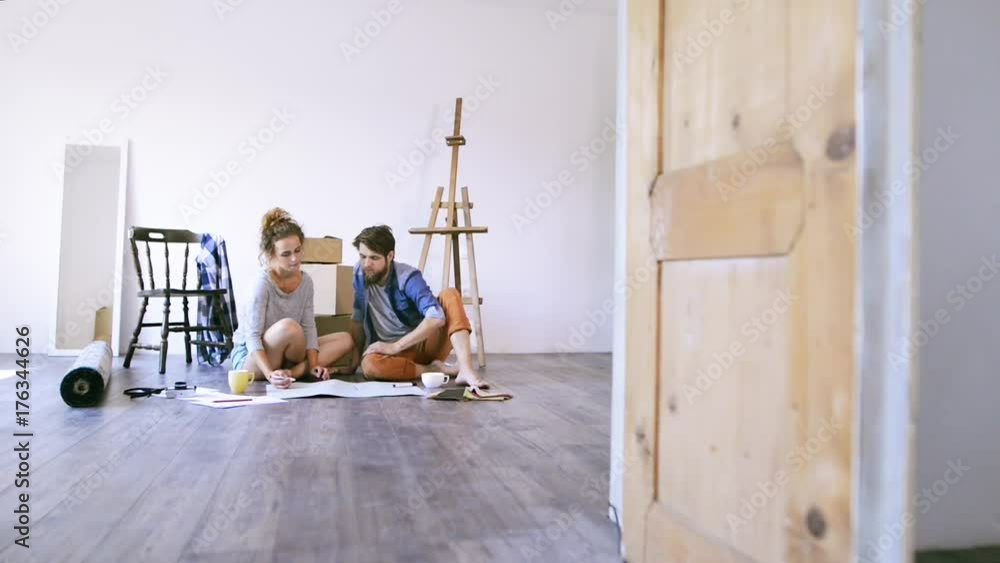 Young couple moving in new house, unpacking things. Young couple moving in new house, unpacking things.