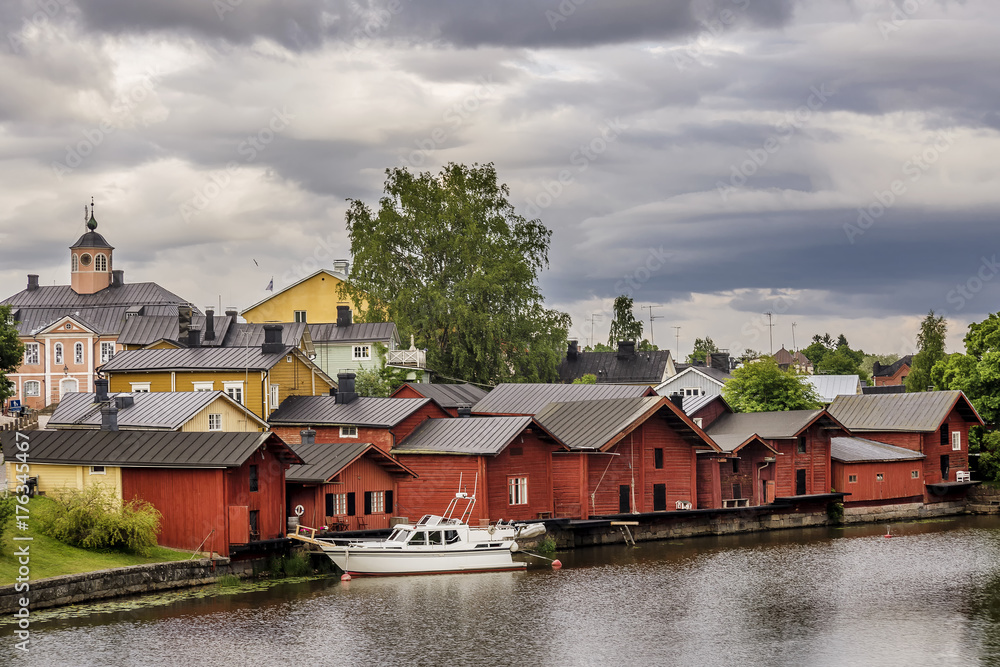 Beautiful view of the old town of Porvoo, Finland, Uusimaa region, with a boat moored near the colorful wooden houses on the river Porvoonjoki