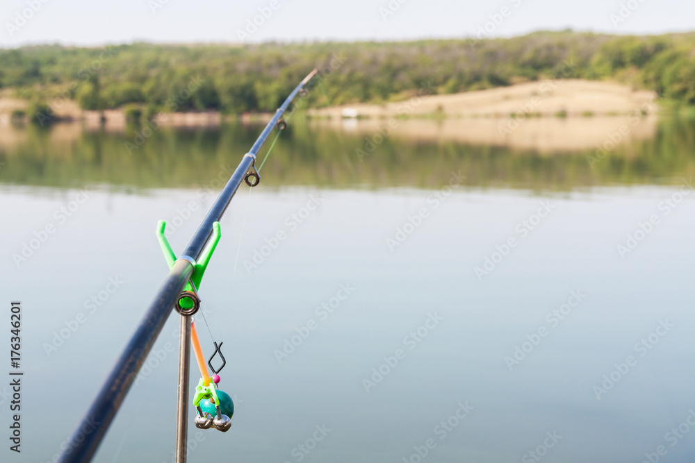 Part of a fishing rod on water background. Selective focus