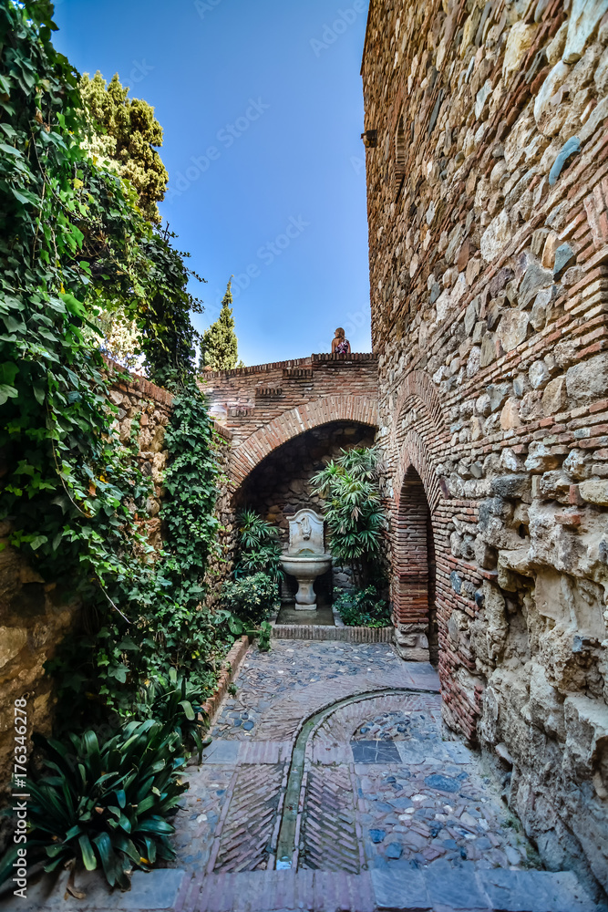 Patio with fountain and plants. Interior of the Alcazaba arab castle in Malaga, Spain.